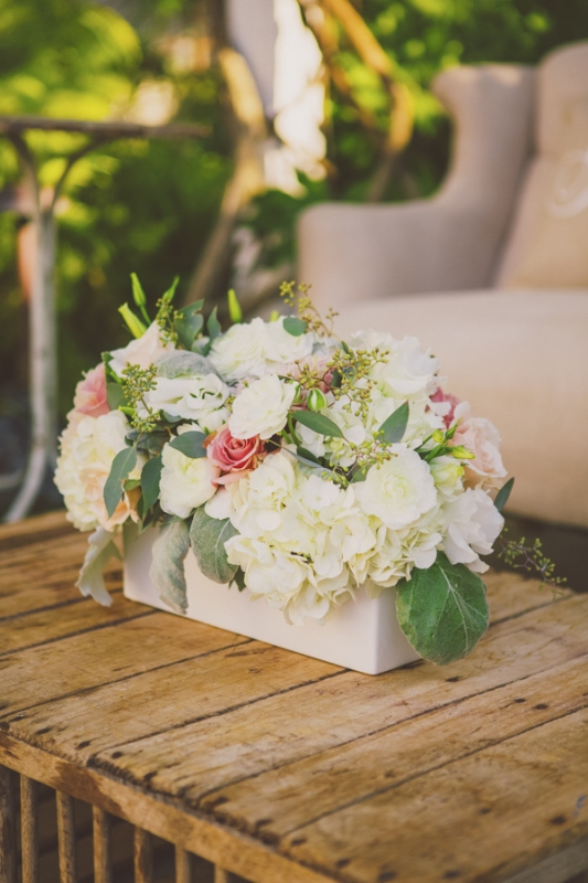 white and pink floral arrangement on rustic wood outdoor table, photo by Closer to Love Photography