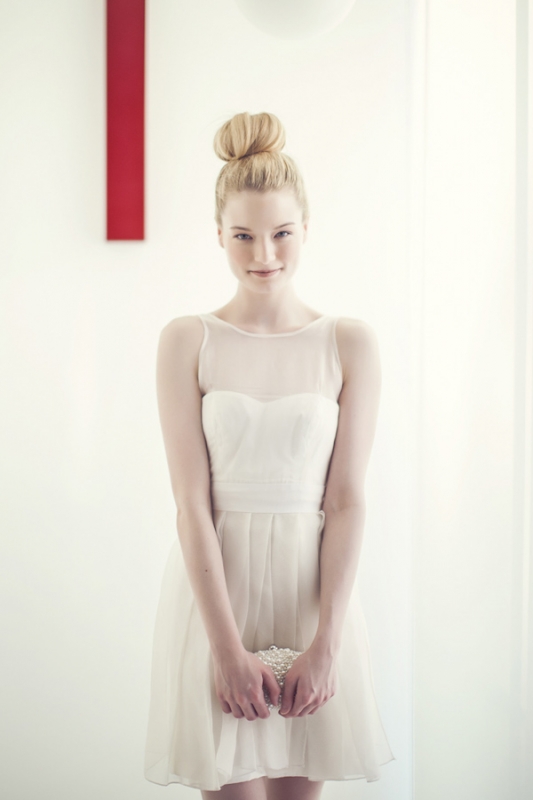 clean top-knot hairstyle and simple short white wedding dress, photo by Studio Uma