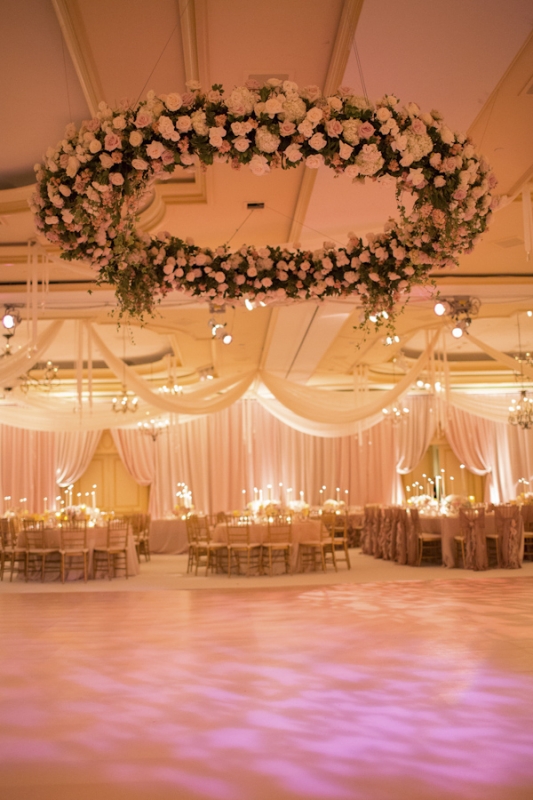 large hanging floral arrangment with pink roses, photo by Ira Lippke Studios
