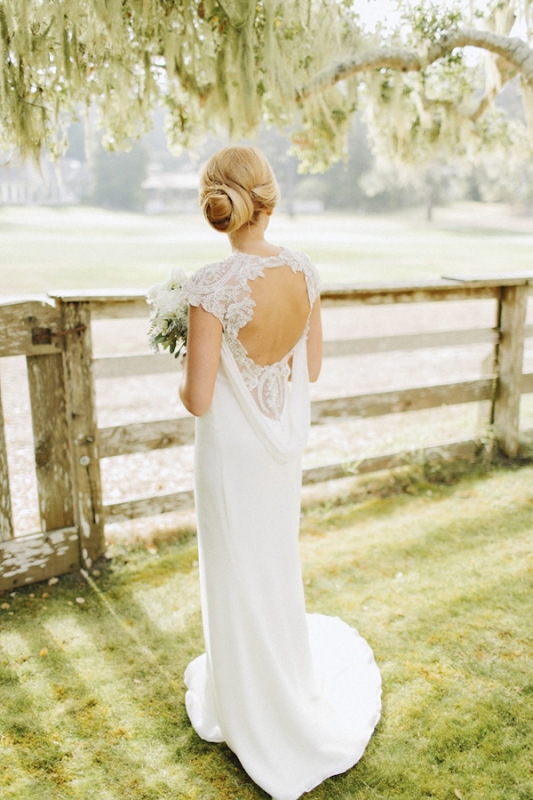 loose chignon hair style and open back wedding dress, photo by Benj Haisch