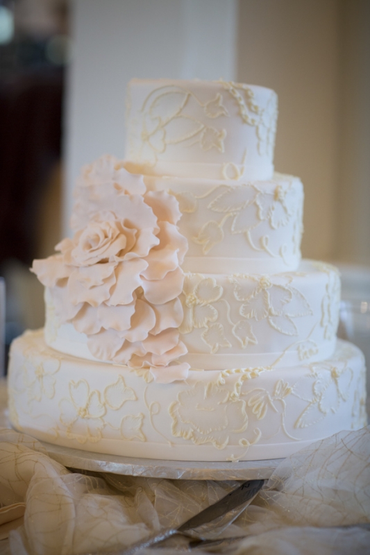 white tiered wedding cake with large white rose flower, photo by Asya Photography