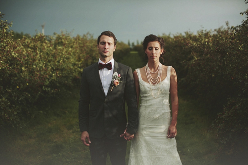 stylish bride and groom with bow tie and pearl necklace, photo by Rowan Jane Photography