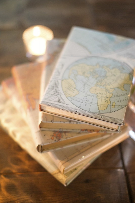 decor centerpieces with map covered books, photo by Paperlily Photography