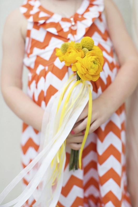 geometric orange flowergirl dress with yellow bouquet, photo by Paperlily Photography