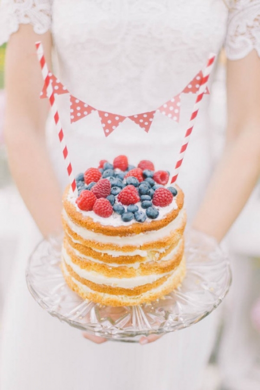 red white and blue mini naked cake with berries and bunting