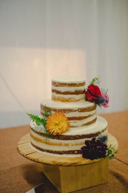 simple smooth naked cake various flowers wooden cake stand