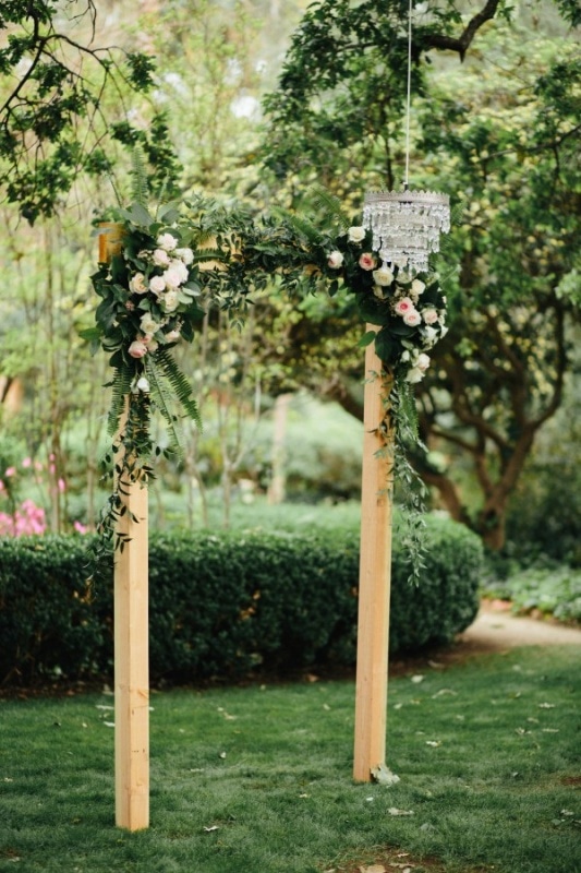 Simple Wooden Ceremony Arch with Flowers and Leaves, Hanging Chandelier