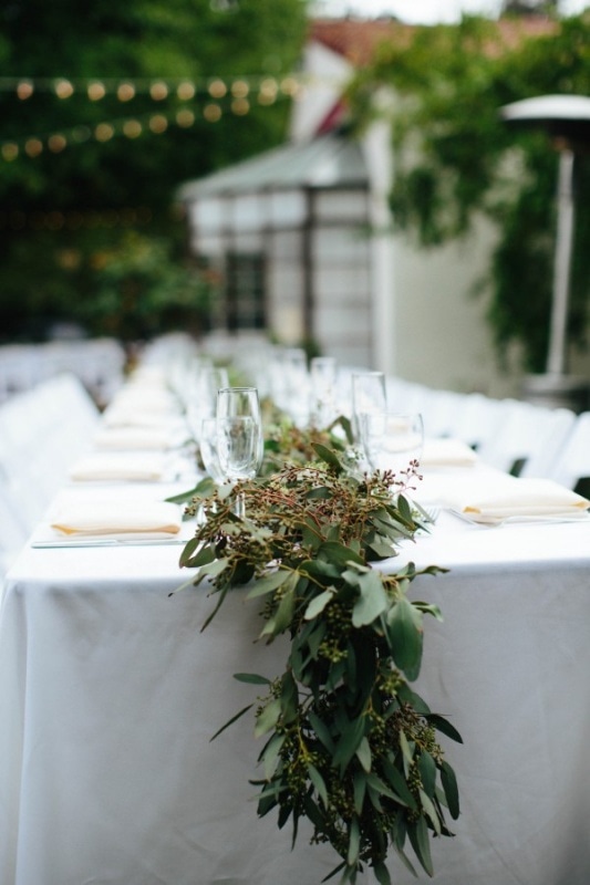 understated reception decor with leaf garland and white table settings