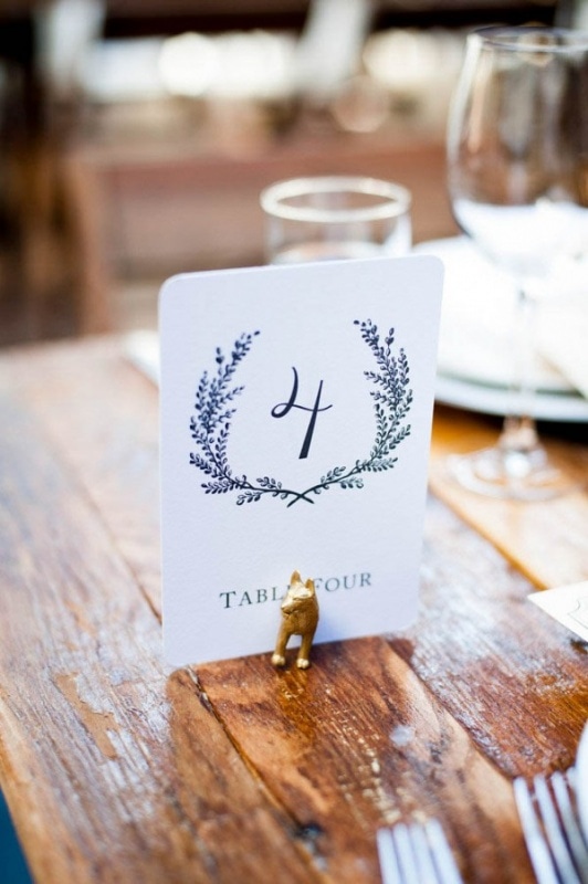 paper table number with quirky gold painted animal holder