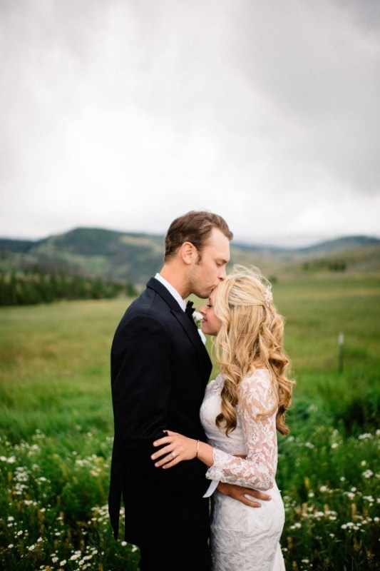sweet couple portrait with groom kissing bride's forehead