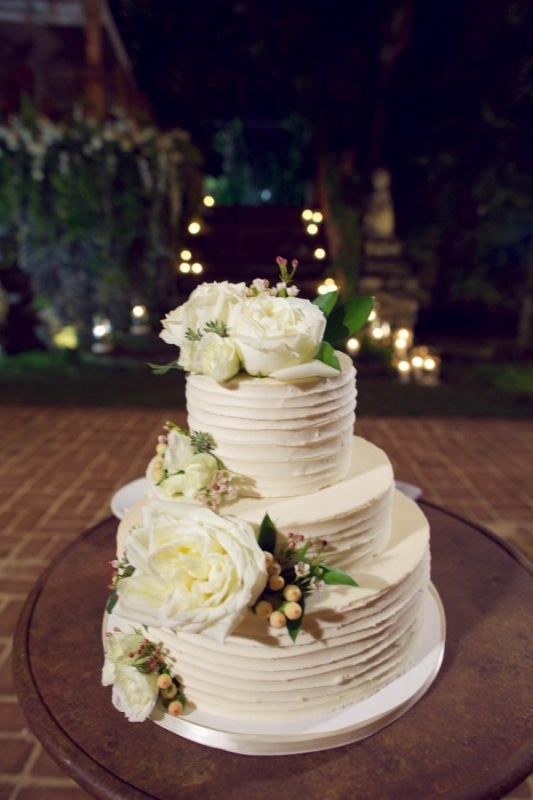 flower adorned tiered wedding cake
