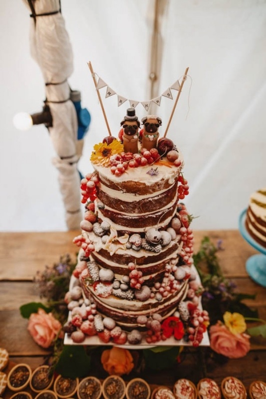 naked tiered wedding cake with berries