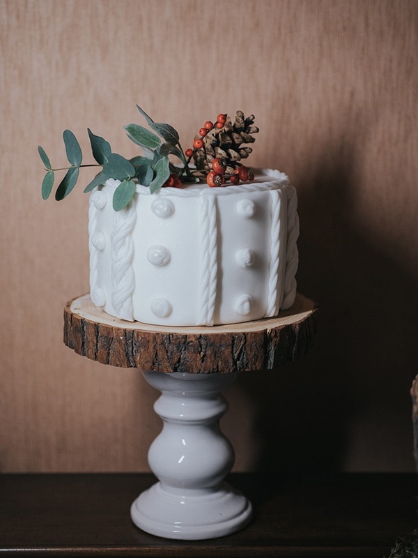 Bright White Wedding Cake with Textured Design and Red Florals