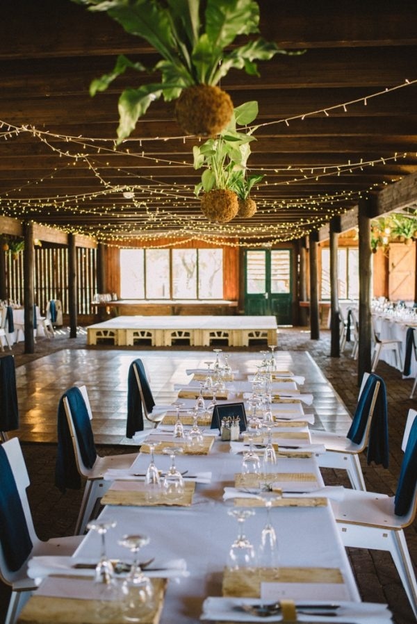 Organic and Rustic Barn Reception with Hanging Plants and Twinkle Lights