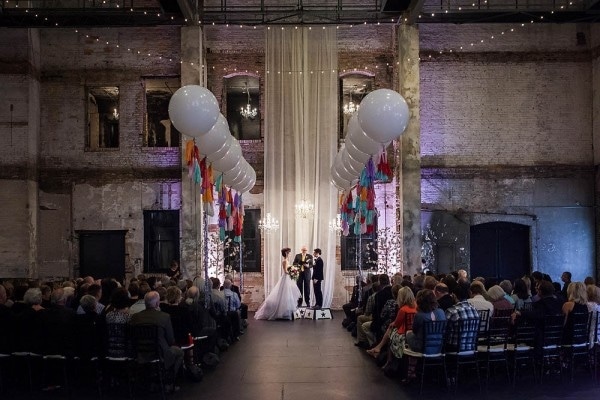 Industrial Circus-Inspired Wedding Ceremony with Large Balloon Aisle Markers