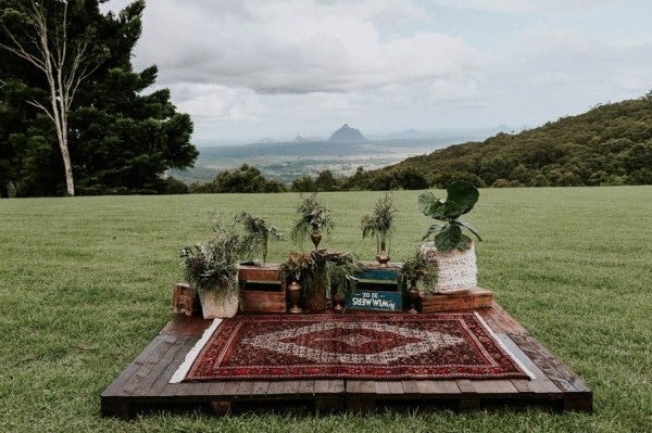Lush Bohemian Ceremony Space with Persian Rug and Greenery Planters