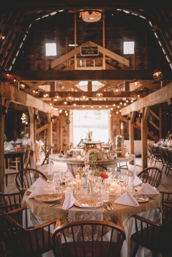 Cozy Barn Reception with White Table Cloths, Burlap and Lace Overlays, Wildflowers, and Cafe Lights