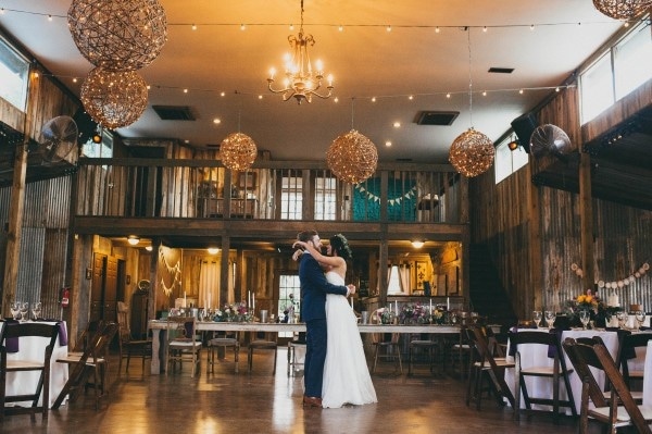 Barn Reception with Woven Globe Light Fixtures and Farm House Tables