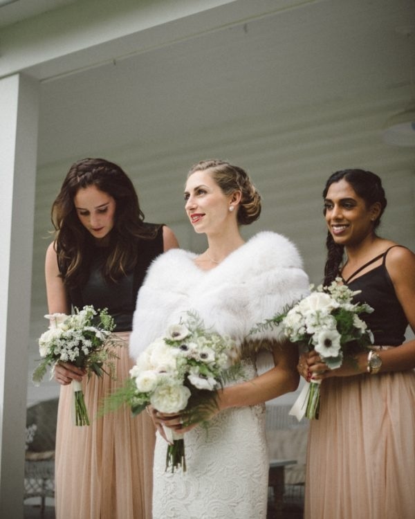 Rustic Glam Bridal and Bridesmaid Style with White Fur Stole, Blush Skirts, and White and Black Bouquets