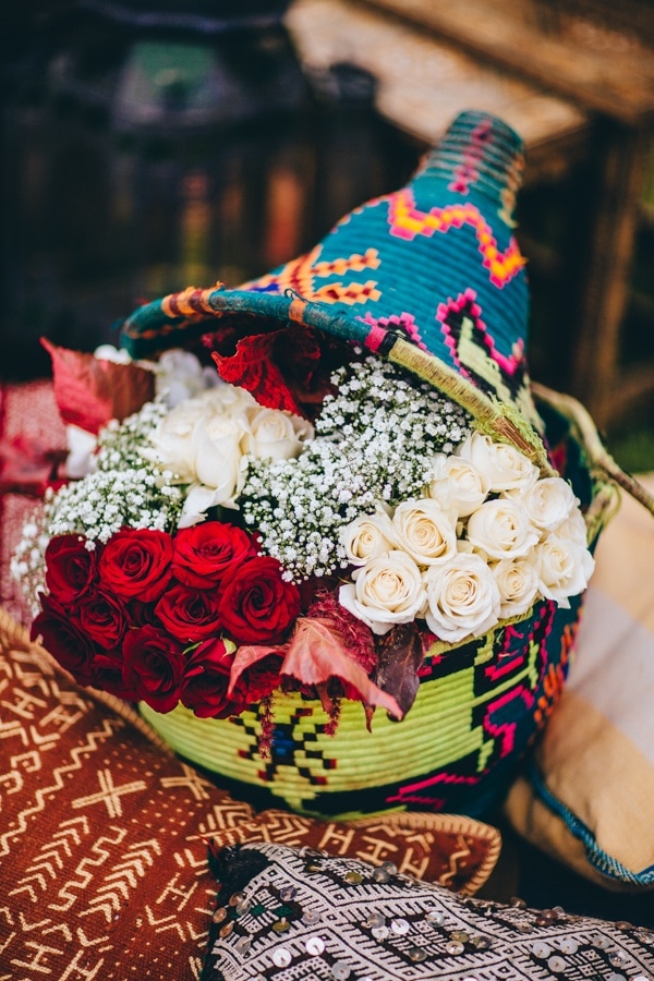 Traditional Colorful Moroccan Floral Display with Woven Basket and Roses