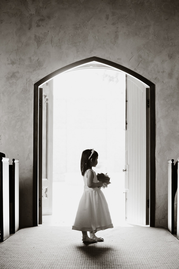 sweet photo of flower girl standing in church aisle - adorable wedding photo by top Australian wedding photographer Darin Collison sweet photo of flower girl standing in church aisle - adorable wedding photo by top Australian wedding photographer Darin Collison
