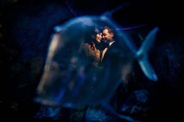 portrait of the happy couple behind fish tank - genius wedding portrait by top Los Angeles wedding photographer Ray Soemarsono of Apertura portrait of the happy couple behind fish tank - genius wedding portrait by top Los Angeles wedding photographer Ray Soemarsono of Apertura