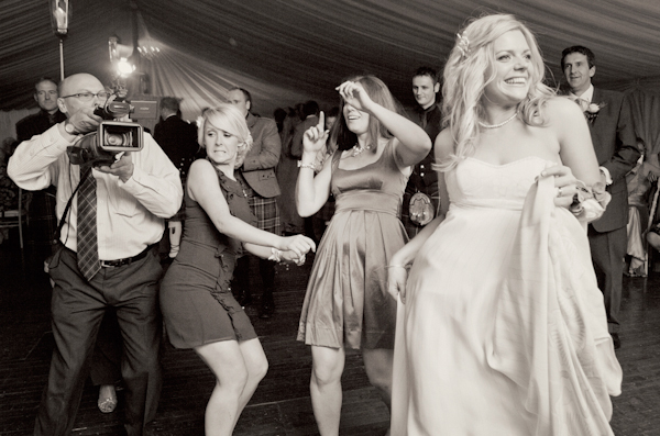 bride and friends dancing while videographer captures - Hilarious wedding reception photo by Sweden-based Lena Larsson | Junebug Weddings bride and friends dancing while videographer captures - Hilarious wedding reception photo by Sweden-based Lena Larsson | Junebug Weddings