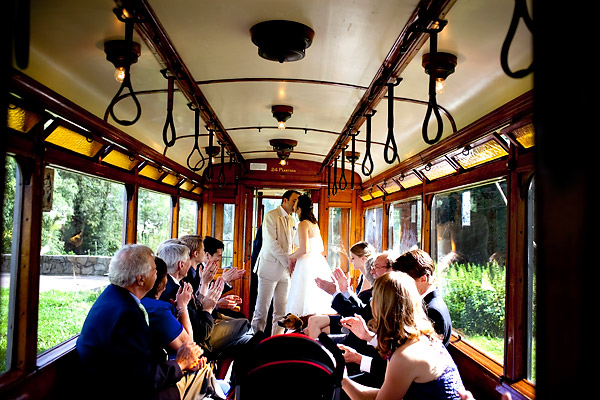 The bride and groom kiss on the trolley as guest clap for them- Amsterdam trolley wedding on Electrische Museumtram - photos by top North Carolina wedding photographer Tracy Turpen Amsterdam trolley wedding on Electrische Museumtram - photos by top North Carolina wedding photographer Tracy Turpen