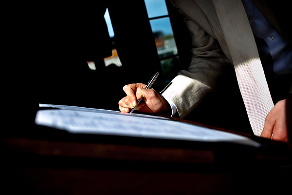 The groom as he signs the papers - Amsterdam trolley wedding on Electrische Museumtram - photos by top North Carolina wedding photographer Tracy Turpen Amsterdam trolley wedding on Electrische Museumtram - photos by top North Carolina wedding photographer Tracy Turpen