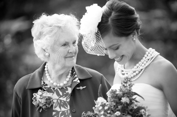 The bride smiles with a family member- New England wedding - Bar Harbor Sorrento, Maine - photos by top east coast wedding photographers Justin and Mary New England wedding - Bar Harbor Sorrento, Maine - photos by top east coast wedding photographers Justin and Mary