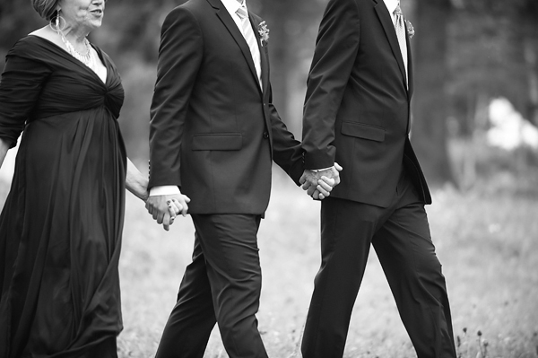 Family and some of the wedding party holding hands on their way to the reception- New England wedding - Bar Harbor Sorrento, Maine - photos by top east coast wedding photographers Justin and Mary New England wedding - Bar Harbor Sorrento, Maine - photos by top east coast wedding photographers Justin and Mary