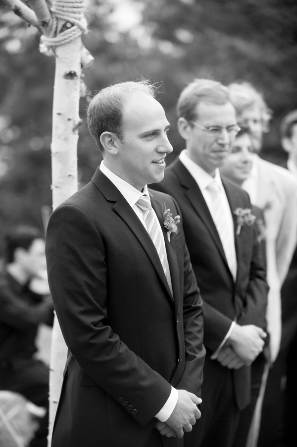 The groom as he watches his bride walk towards him down the aisle- New England wedding - Bar Harbor Sorrento, Maine - photos by top east coast wedding photographers Justin and Mary New England wedding - Bar Harbor Sorrento, Maine - photos by top east coast wedding photographers Justin and Mary