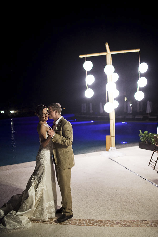 night shot of the happy couple dancing together poolside - Riviera Maya, Mexico destination wedding - photo by Dallas based wedding photographer Jeremy Gilliam