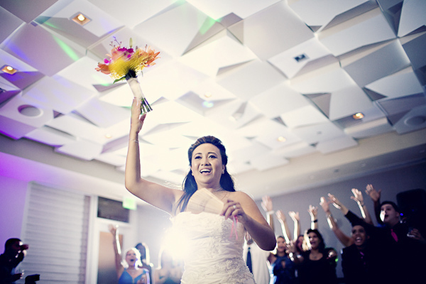 bride tossing bouquet during reception - wedding traditions photo by top Florida based wedding photographer Kat Braman bride tossing bouquet during reception - wedding traditions photo by top Florida based wedding photographer Kat Braman