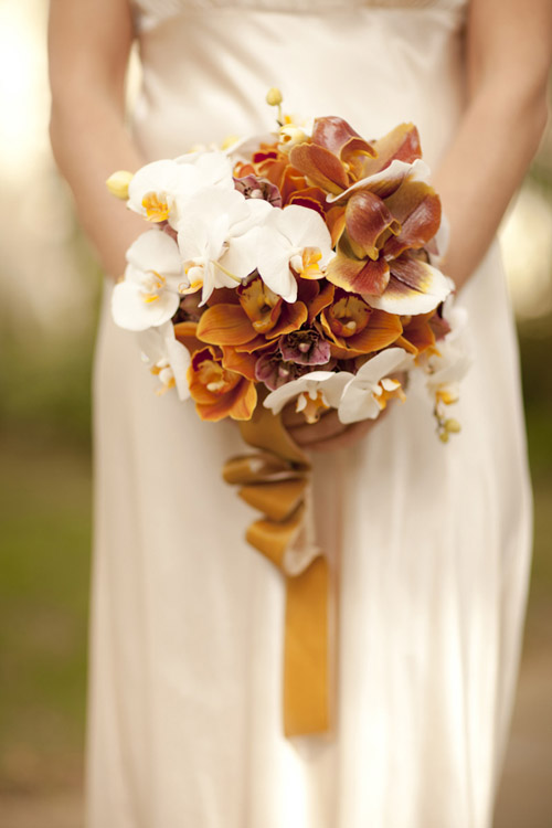 orange and cream fall orchid wedding bouquet by Louloudi Design, photo by Allyson Magda | junebugweddings.com