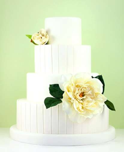Beautiful white modern fondant wedding cake with pretty floral decoration from Eat Cake Be Merry
