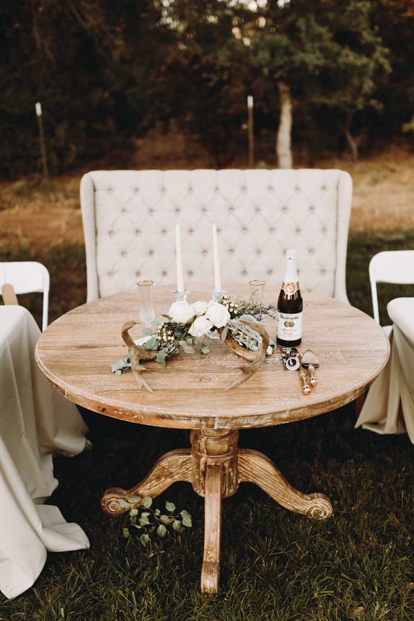 rustic glam sweetheart table with round table and loveseat