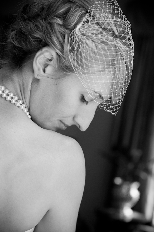 Black and white photo of beautiful bride wearing birdcage veil and ...