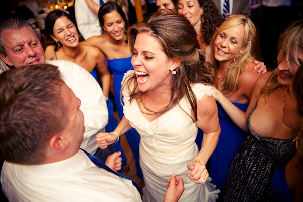 portrait of ecstatic bride and groom at wedding reception - photo by ...