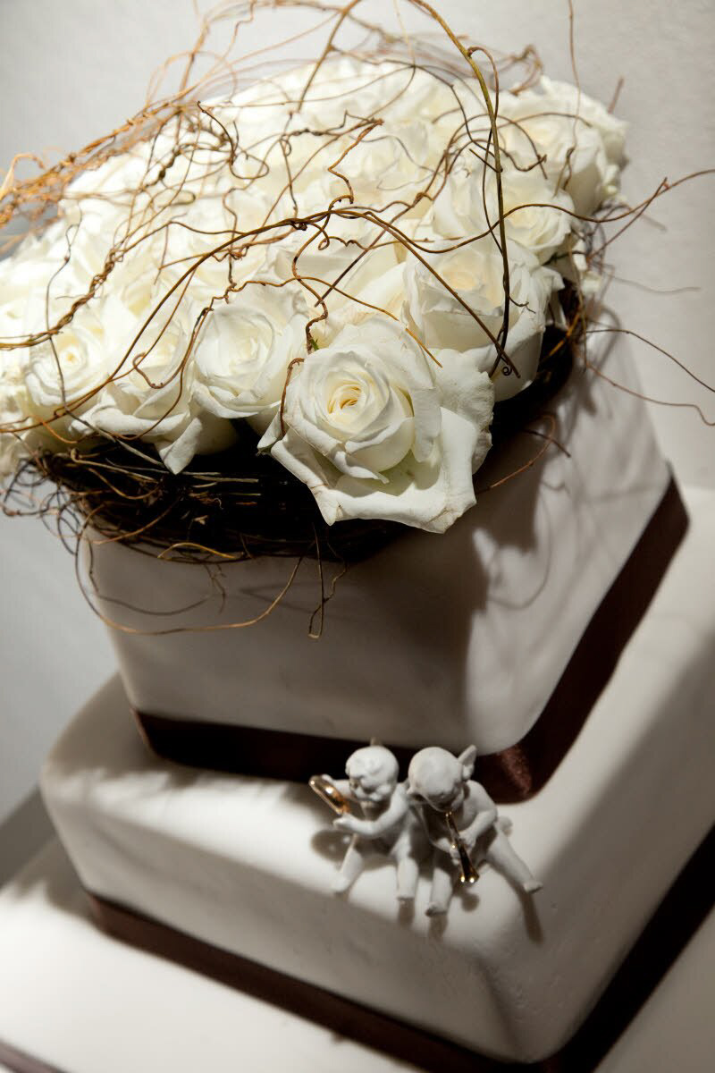 White Tiered Wedding Cake With Golden Brown Borders Basket Of White