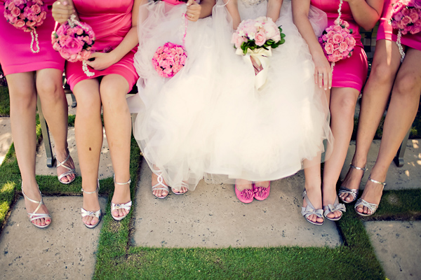 Bride in white dress and pink shoes and bridesmaids in pink dresses and ...