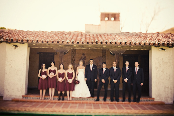 Bridal Party Standing On Patio Of Spanish Style Building Bride