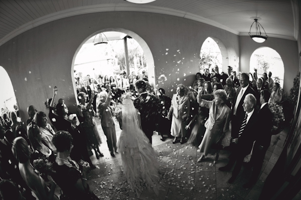 wide angle perspective of couple exiting ceremony - wedding photo by ...