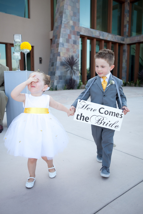 Cute little girl in tulle dress with yellow sash and boy in gray suit with yellow tie - Photo by April Smith & Co.