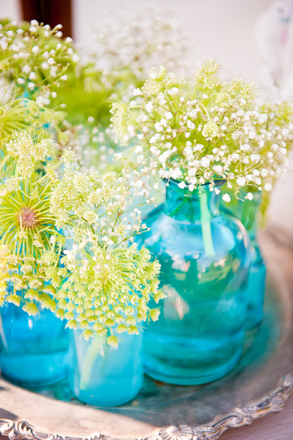 Colorful aqua and green flower vases on display at wedding - Wedding Photos by Elizabeth Davis
