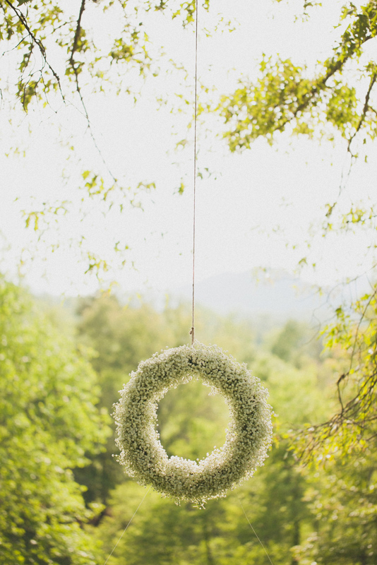 Hanging white floral wreath - Photo by The Schultzes