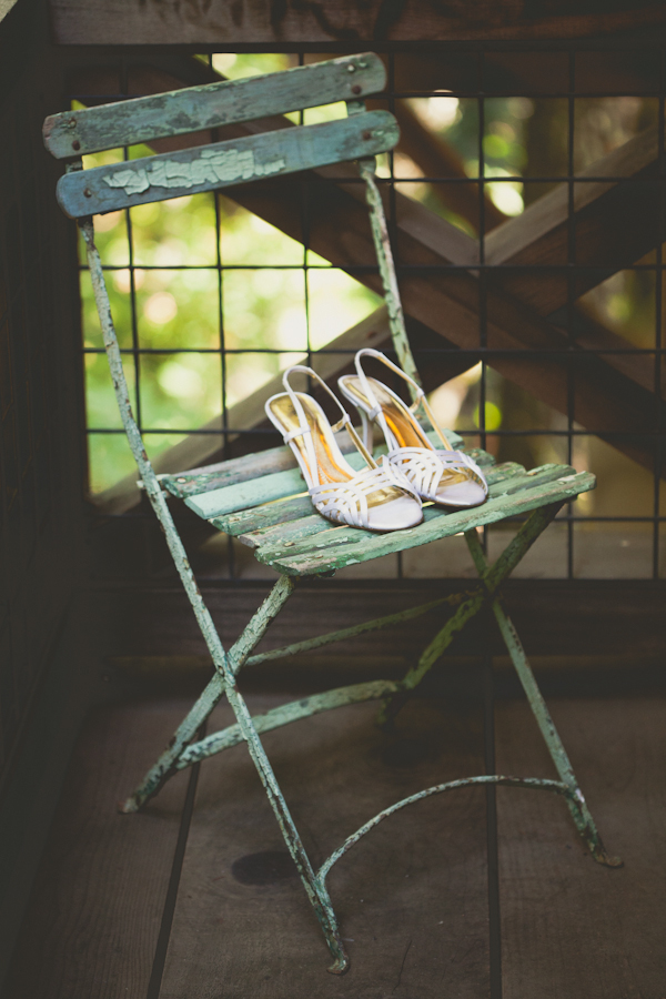 bridal shoes rest on green vintage chair - warm, sunny, Sonoma California vineyard wedding photo by California wedding photographers EP Love