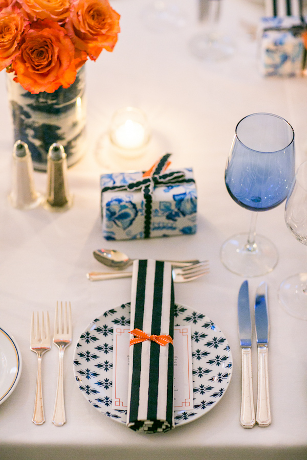Nautical inspired table setting with striped napkin and orange roses - Photo by Sarah Tew Photography