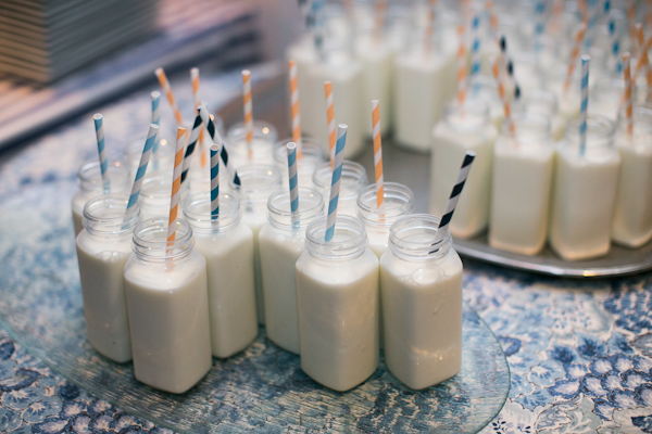 Jars of milk with multicolored striped straws for weddng reception - Photo by Sarah Tew Photography
