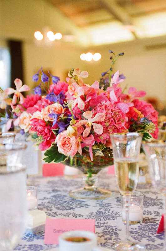 Bright pink floral centerpiece with violet and peach accents - Photo by Sylvie Gil Photography